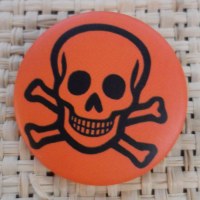 Badge tête de mort souriante orange